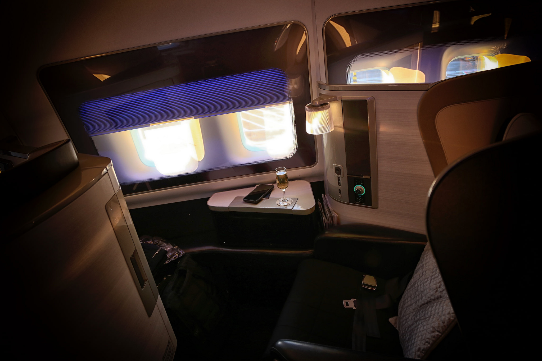 First class seat on British Airways with window shades halfway down