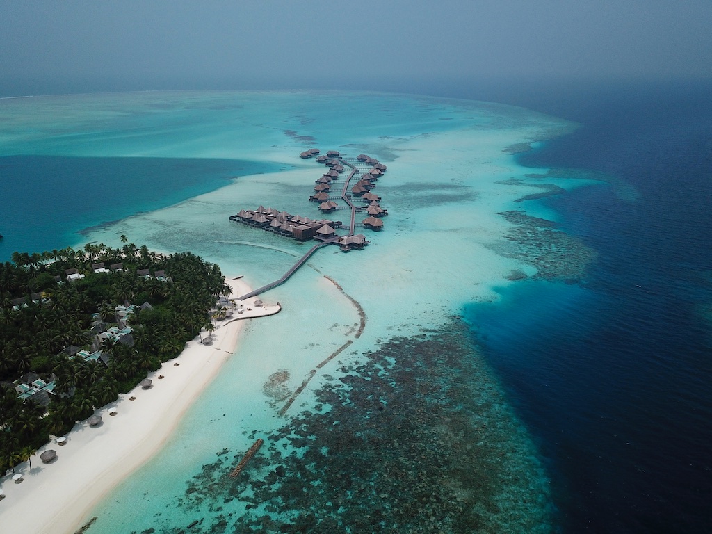 Aerial view of overwater villas at Conrad Maldives.