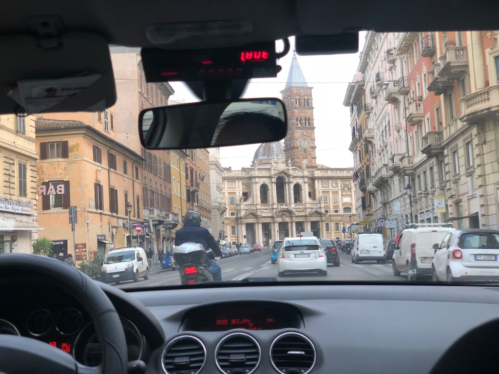 Picture looking out from a taxi cab in Italy near a train station