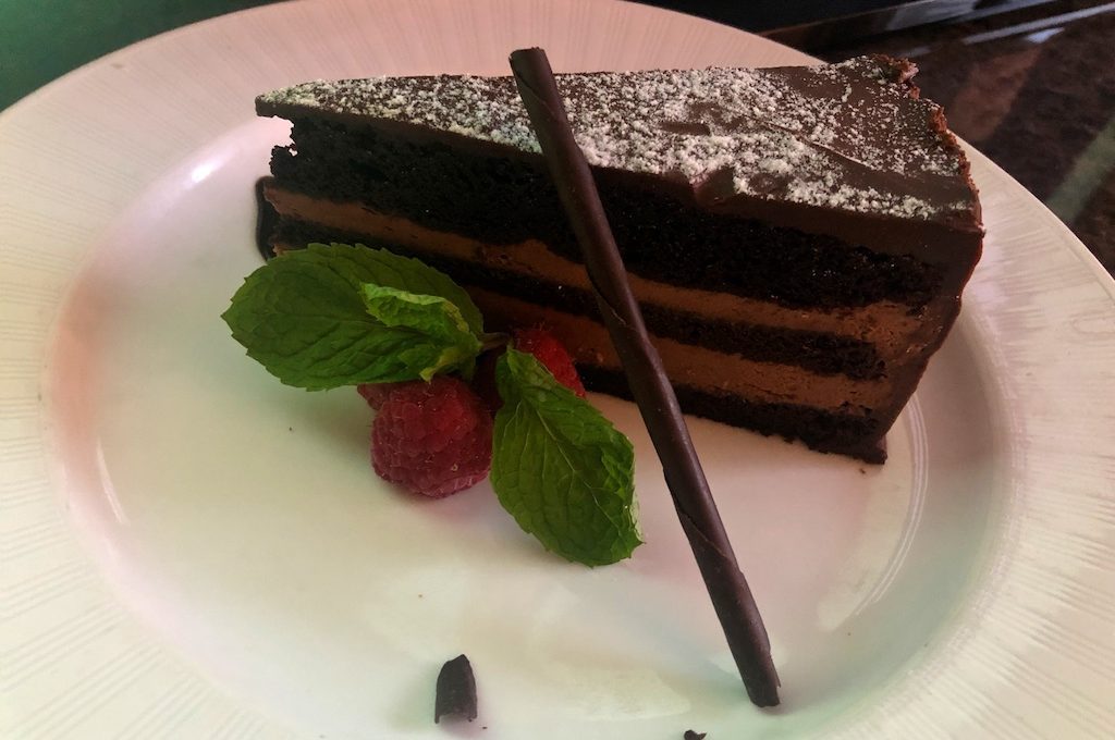 Chocolate cake with mint and raspberry garnish at The St. Regis Houston.