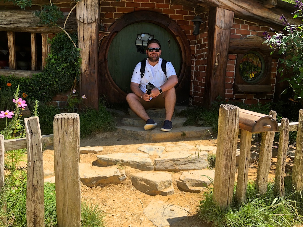 Man at hobbit hole Hobbiton Movie Set Tour