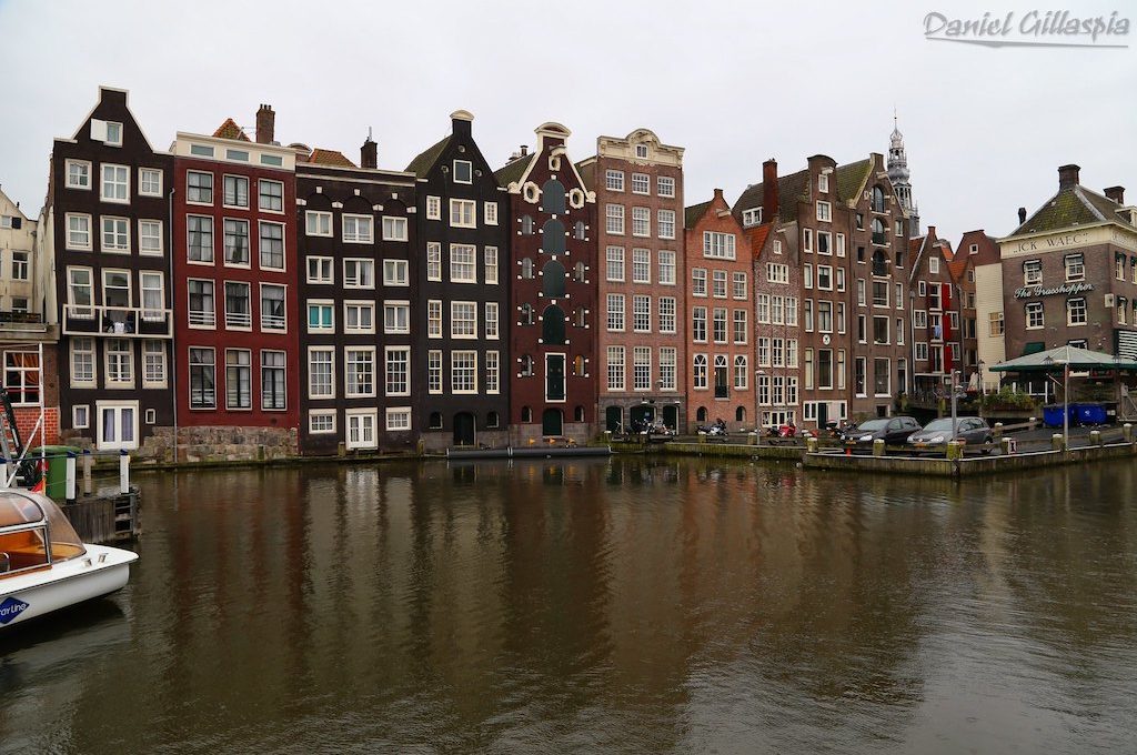 Buildings line canal in Amsterdam