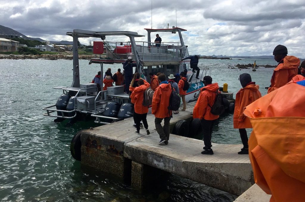 Group of people loading on boat