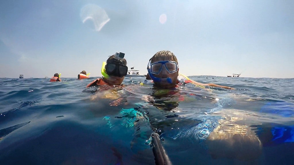 Men wearing snorkels in water