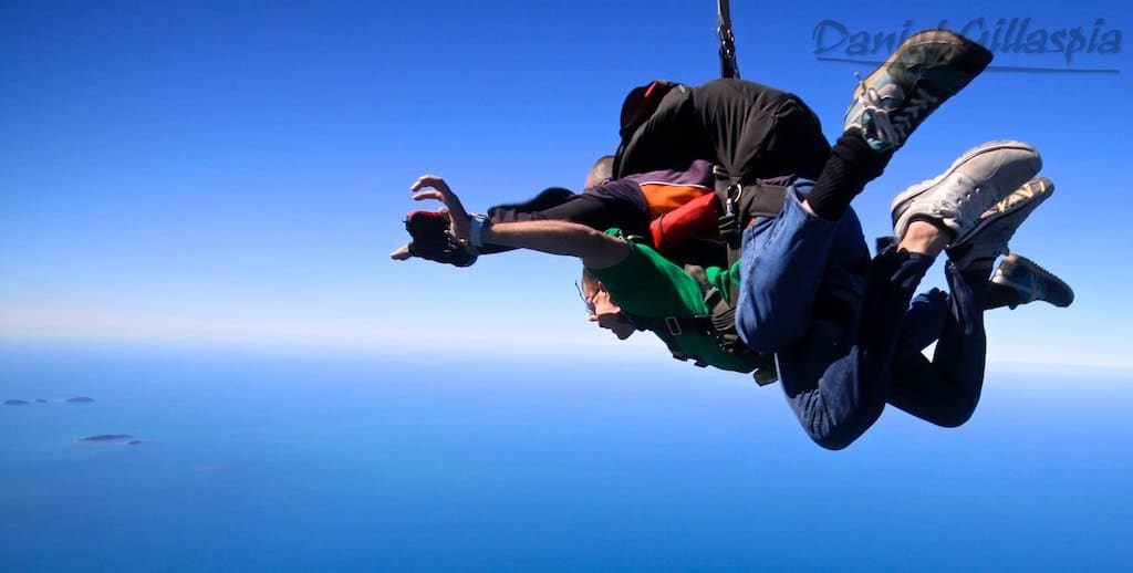 Tandem skydiving over ocean