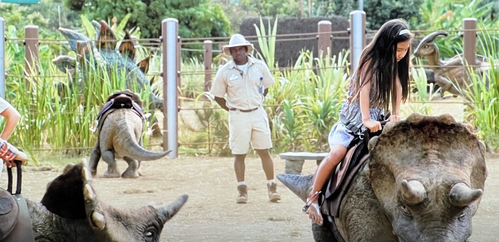 Honolulu Zoo, kids riding dinosaurs Jurassic World movie scene.