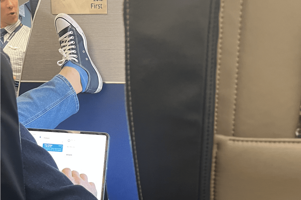 Passenger with foot on bulkhead