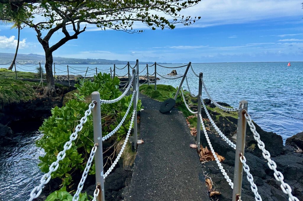 Narrow walking bridge overlooking ocean at Hilton DoubleTree Hilo