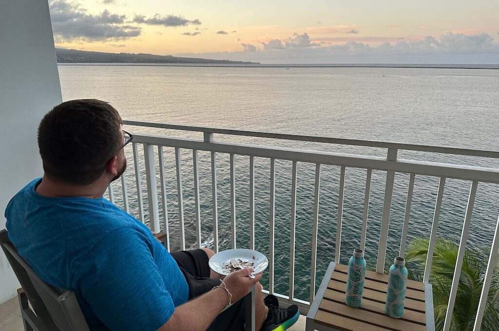 Man sitting on balcony at Hilton DoubleTree Hilo