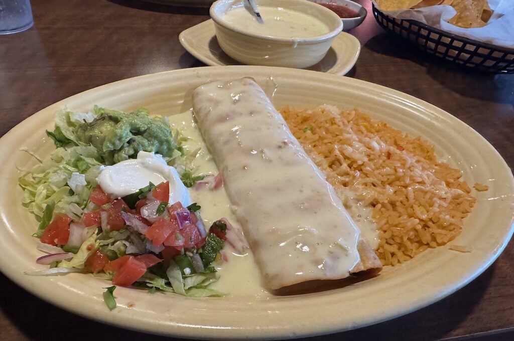 Chimichanga topped with cheese sauce
