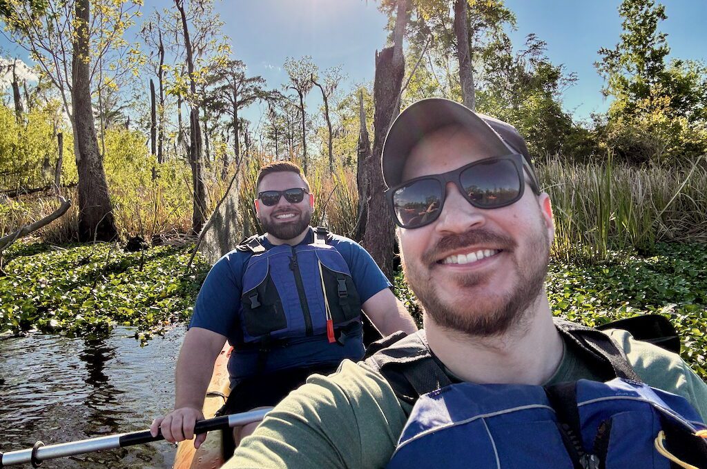 Two men in kayak in Manchac swamp