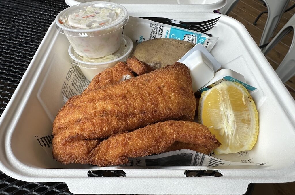 Breaded fried fish, lemon and baked potato