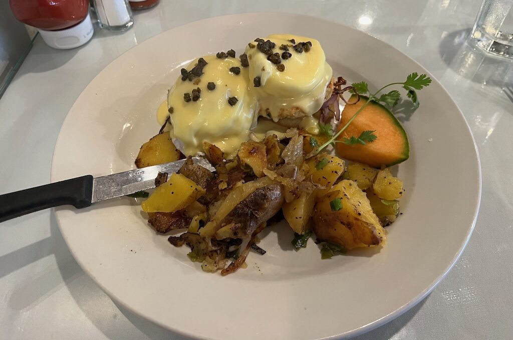Crab cake benedict with grilled potatoes at Sandpiper Cafe Juneau