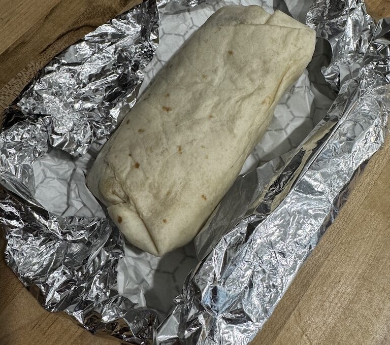 Breakfast burrito sitting on foil