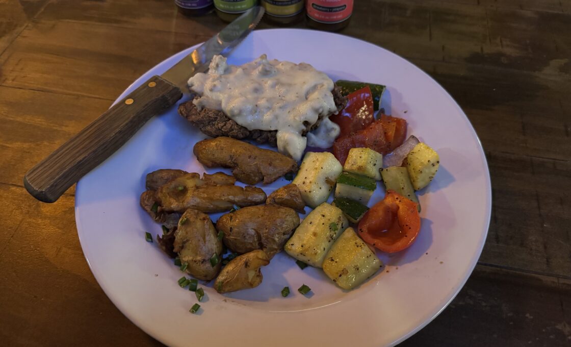 Chicken-fried yak with smashed fingerling potatoes and sautéed veggies