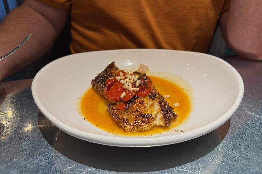 Blackened Cod with roasted red peppers and pine nuts