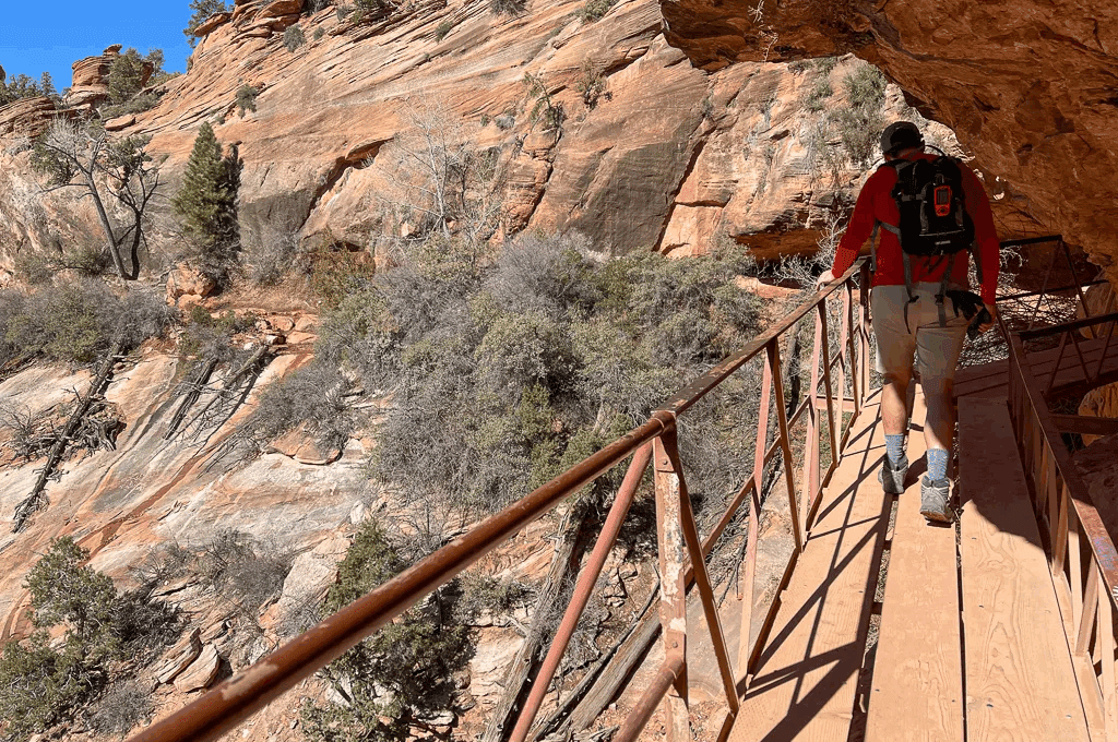 Man hiking on raill pathway on the Zion Canyon overlook Trail